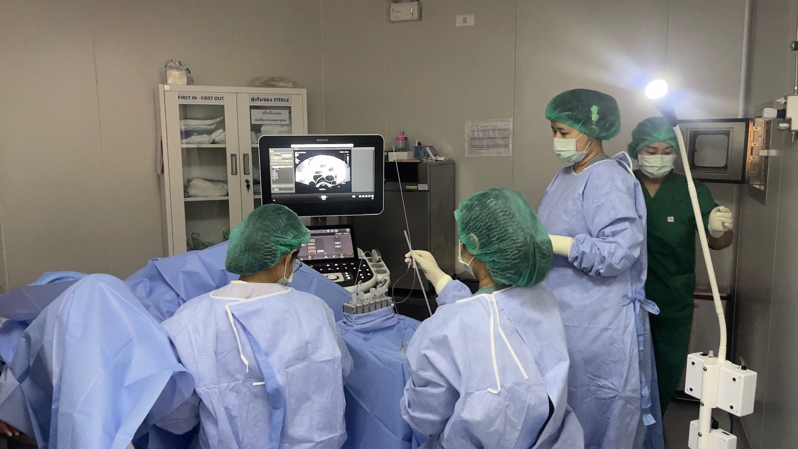 The clinical team performing an ultrasound-guided embryo transfer
