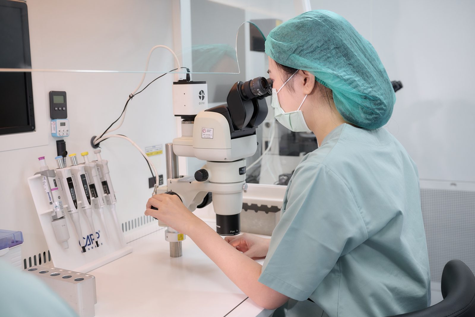 An embryologist working at the microscope in the Angel Baby IVF laboratory